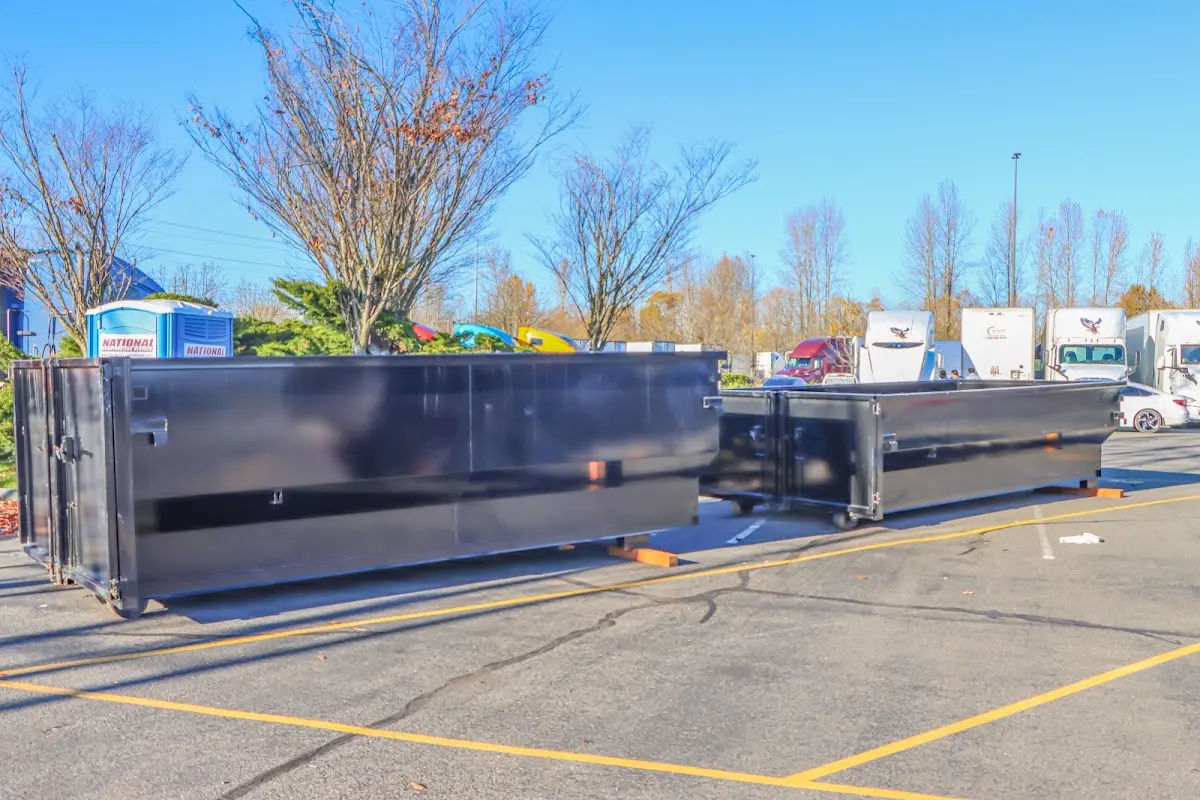 Professional dumpster rental service with roll-off container on residential driveway in The Dalles